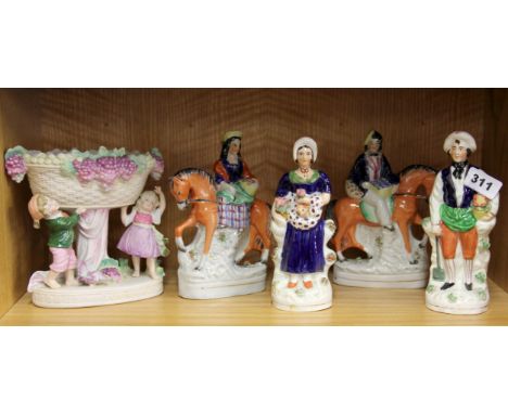 A group of four 19th Century Staffordshire figures, together with a porcelain centerpiece, H. 20cm.