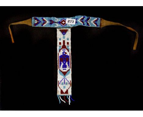An item of Native American beadwork on leather, L. 32cm.