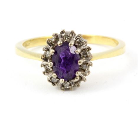 An 18ct yellow gold amethyst and diamond cluster ring, (Q).