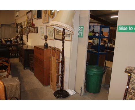 A mahogany standard lamp and shade
