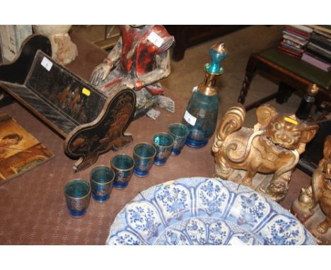 A blue glass liqueur decanter with a set of six matching glasses with gilt decoration