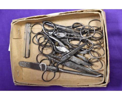 A selection of vintage seamstress or needlework scissors, button hook etc