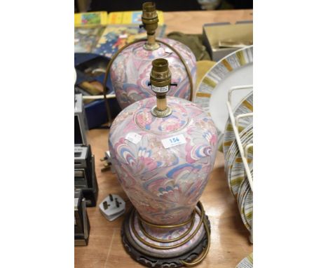 Two ginger jar formed lamp bases, having psychedelic feather like design in pink and blue hues.