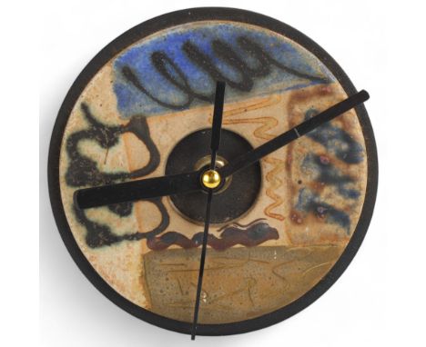A 20th century studio ceramic quartz clock on steel frame, unsigned, diameter 12cmceramic panel in good condition, clock in w