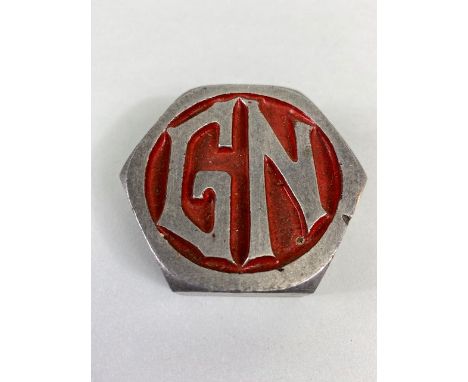 Vintage Car Motor Vehicle threaded alloy hub cap with the letters G N on a red background,  approximately 6cm across