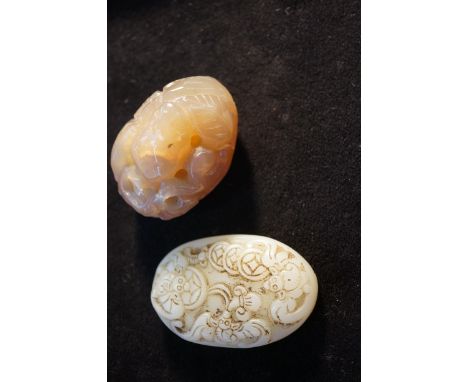 Carved piece of jade together with a carved polished hard stone 