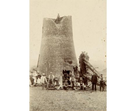 PHOTOGRAPHS Five black and white portraits and views, comprising a group at the foot of a windmill with broken sails, by F.H.