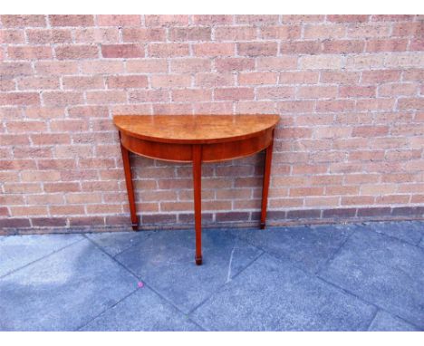 A DEMI-LUNE SIDE TABLE on square tapering supports with spade feet, 92cm wide 42cm deep 74ch high