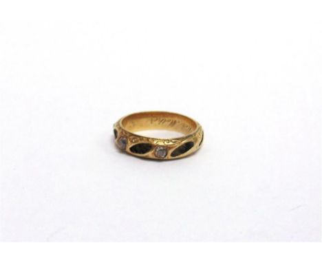 A VICTORIAN DIAMOND SET MOURNING RING  the three old cut stones, totalling approximately 0.15 carats, between plaited hair pa