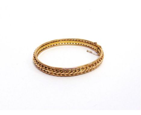 AN EARLY 20TH CENTURY HINGED BANGLE unmarked, of barley twist and bead design, 5.7cm internal diameter, 14g gross, later case