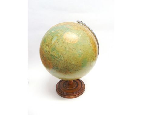 A PHILIPS 19 INCH TERRESTRIAL GLOBE with a chrome arm, on a turned wooden base, 63cm high. 