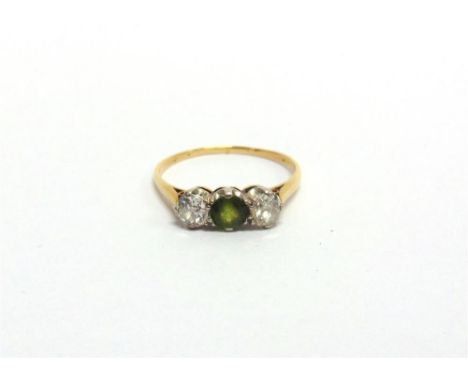 A GREEN TOURMALINE AND DIAMOND THREE STONE RING the round cut tourmaline flanked by old brilliant cuts totalling approximatel