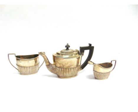 A THREE PIECE SILVER MATCHED BACHELORS TEA SERVICE Birmingham 1905 and 1907, of oval gadrooned form, 425g (13.7 troy ozs) gro