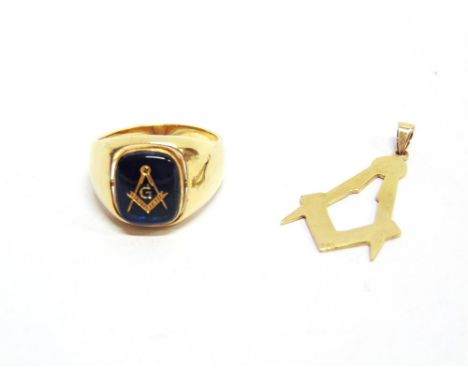 A MASONIC RING stamped '585', set with a blue stone having a set square and compass to the centre; with a set square and comp