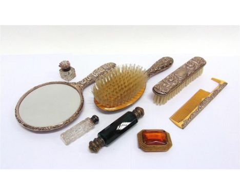 A SILVER HAND MIRROR hair brush, and clothes brush; with two scent bottles; a small glass inkwell; a comb; and a costume jewe