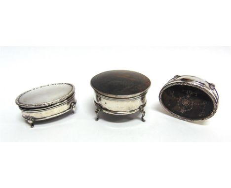 A SILVER AND TORTOISESHELL TRINKET BOX marks worn, of circular outline, on four supports, 8cm diameter; with an oval silver a