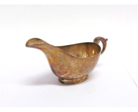 A LATE VICTORIAN SILVER SAUCEBOAT  by William Hutton & Son, Sheffield 1900, of good gauge, on a rim foot with a leaf capped d