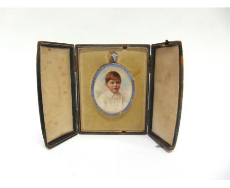 A HAND COLOURED PORTRAIT OF A YOUNG BOY circa 1930, in an oval pale blue guilloche enamel frame, the reverse of the card note