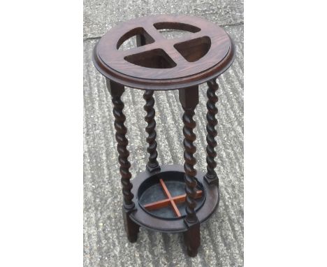 An early 20th century oak barley twist stick stand