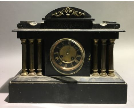 A Victorian black slate mantle clock