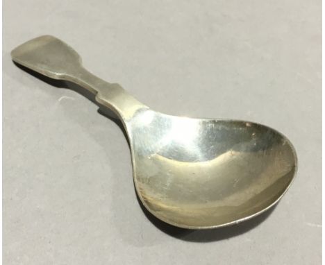 A silver caddy spoon