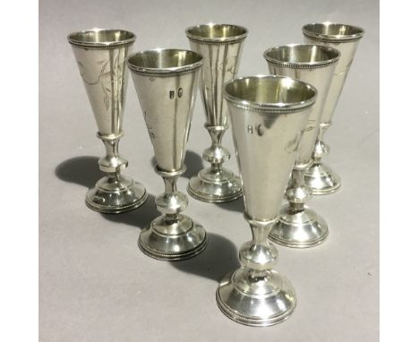 Six Russian silver vodka cups each engraved with bird and leaf decoration, 84 mark, maker H.3.M