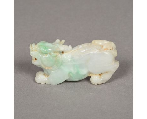 A Chinese carved pale green jade temple lion8 cm long. 