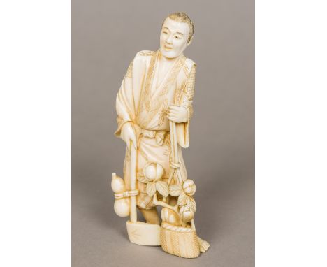 A 19th century Japanese carved ivory okimono Worked as a woodsman carrying an axe and a basket of fruiting boughs, signed.  1