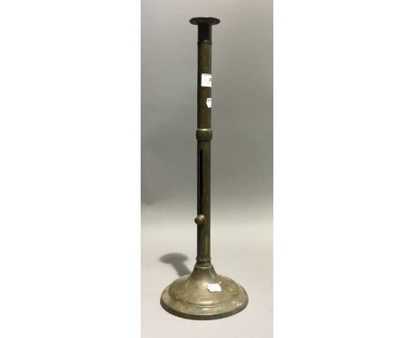 An 18th century elongated brass ejector candlestick