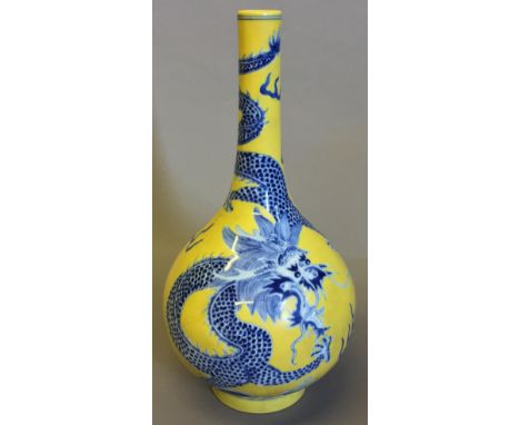 A Chinese porcelain vaseDecorated with a dragon and leaping carp above stylised waves on a yellow ground, blue painted six ch