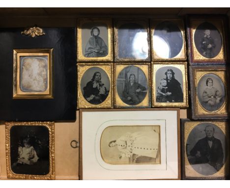 An early Victorian papier mache frame containing a photographic portrait, stamped Beard, Patentee and eleven other Victorian 
