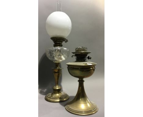 A brass oil lamp, flue and shade, together with another