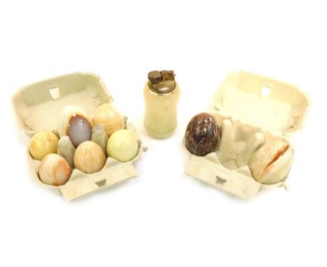 Eight onyx eggs, of varying colourways, 7cm high, and an onyx and brass table lighter, 12cm high. (9)