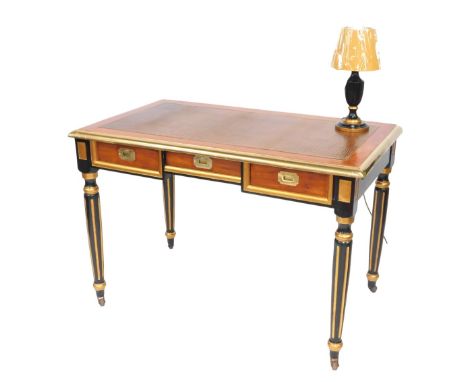 A 20thC French style writing desk, the top inset with a mock crocodile panel, with three frieze drawers, on reeded cylindrica