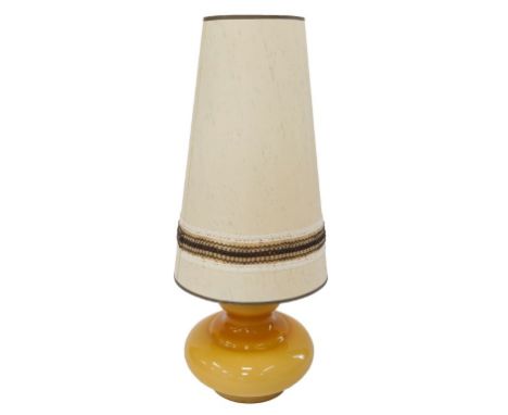 A mid century German amber glass table lamp, of compressed circular form, on brassed circular base with conical tapering shad