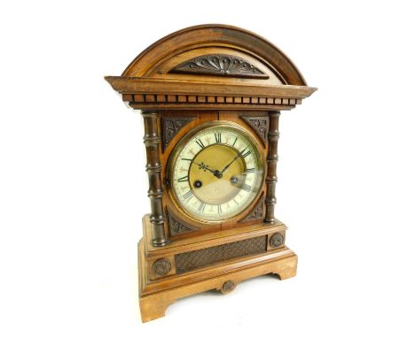 A late 19thC/early 20thC German HAC 14 day strike oak cased mantel clock, the brass circular dial with cream enamelled chapte