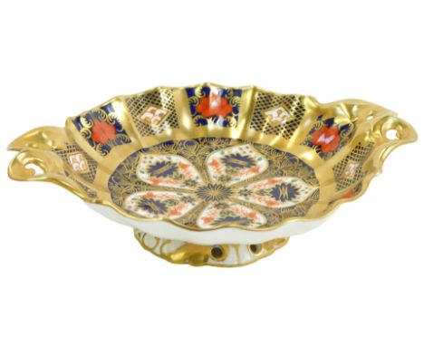 A Royal Crown Derby Old Imari porcelain twin handled pedestal sweetmeat dish, gold ground, pattern 1128, red printed marks, 1