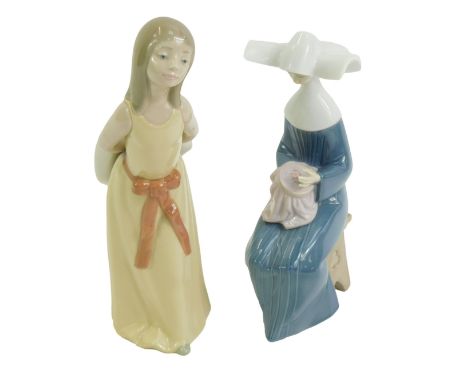 Two Lladro porcelain figures, modelled as a lady wearing a yellow dress holding a hat, 24cm high, and a figure of a nun seate