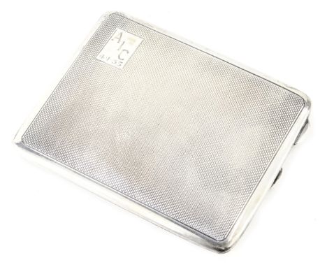 A George V silver cigarette case, of rectangular form with engine turned decoration, bearing the initials AIC 4.1.35, maker M