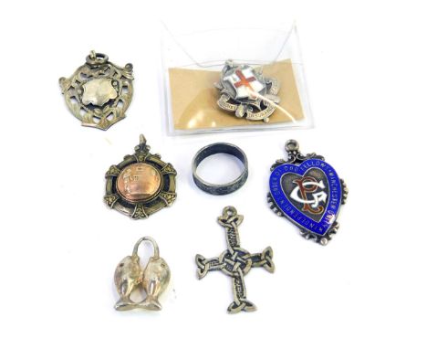 Silver wares, comprising four silver crests, two enamel set, a white metal two mounted fish pendant, unmarked, a crucifix sta