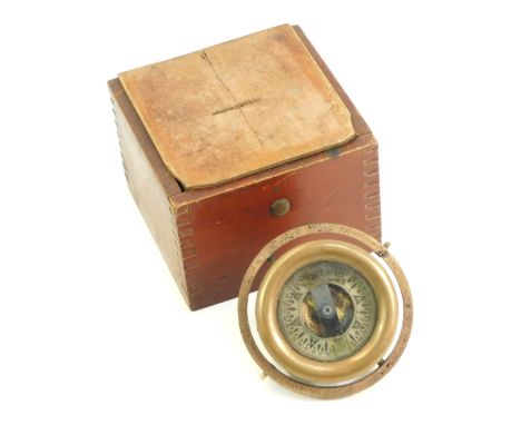 A brass ship's compass, contained in a stained pine case, 12cm wide.