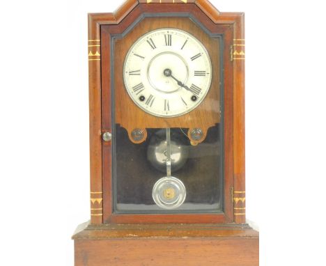 An early 20thC mahogany cased American mantel clock, the white enamel dial bearing Roman numerals, eight day movement, the ca