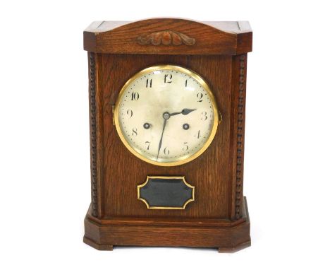 An early 20thC oak cased mantel clock, circular silvered dial bearing Arabic numerals, Junghans A42 eight day movement, with 