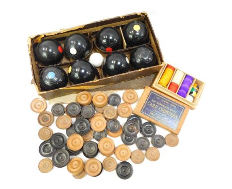 A Banda carpet bowls set, boxed, together with various turned boxwood draughts counters, and a boxed set of Veteran Series co