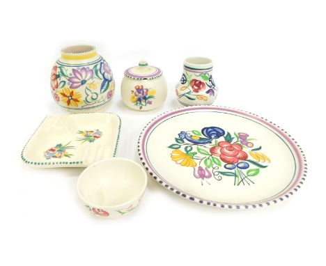 A group of Poole pottery, traditionally decorated with floral sprays, to include condiment pot and cover, 9cm high, ashtray, 