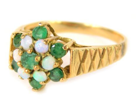 A 9ct gold floral cluster dress ring, set with an opal and emerald, with cross hatched shoulders, with rubbed hallmarks, size