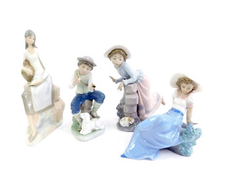 A group of Nao porcelain, comprising young girl leaning against stone wall beside a puppy, 23cm high, young boy seated beside