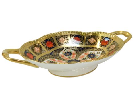 A Royal Crown Derby Old Imari porcelain twin handled oval pedestal sweetmeat dish, gold ground, pattern 1128, red printed mar