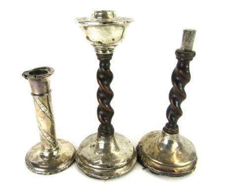 A pair of Edward VII silver and oak twist column candlesticks, 22cm high, and a white metal ribbed candlestick on weighted ba