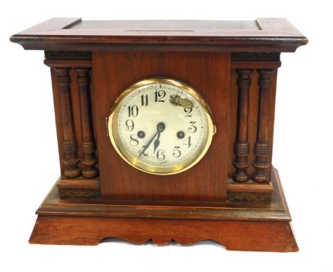 A mid 20thC stained mahogany and pine cased mantel clock, the silvered dial bearing Arabic numerals, eight day movement with 